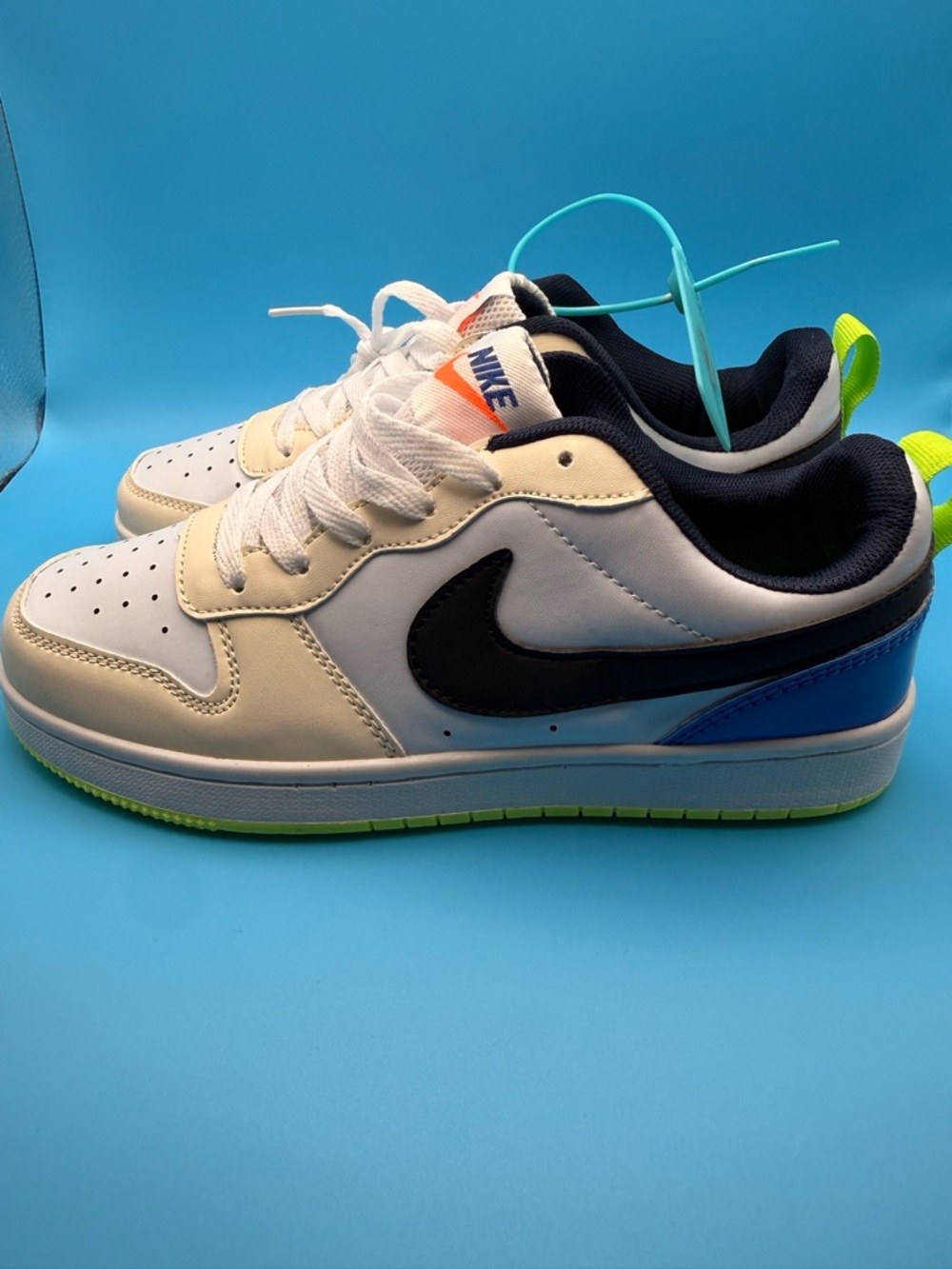 Nike Kids White Sneaker with Black Swoosh, Blue Heel and Neon Green Accents